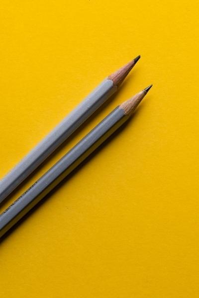 2 pencils on yellow background
